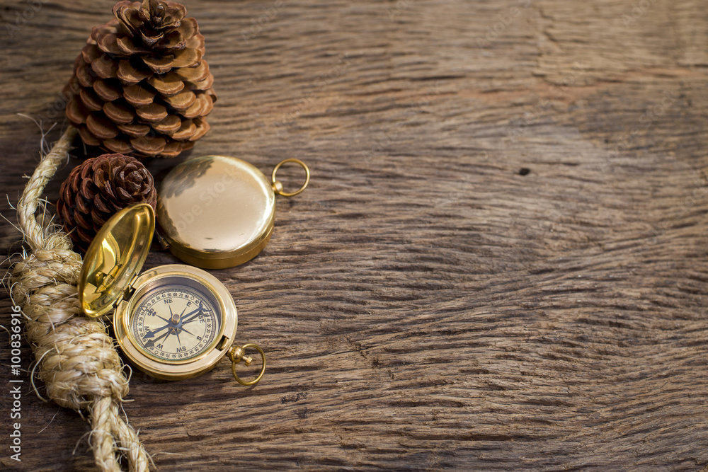 Old Compass and rope on wood background Old Compass and rope on wood background