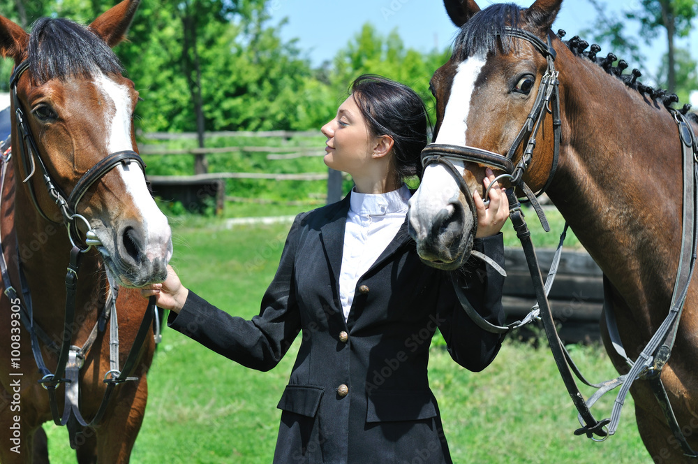 Obraz premium young horsewoman with two horse