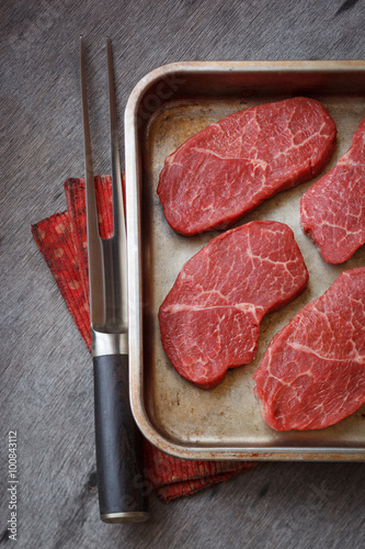 Raw marbled  beef steak in a pan