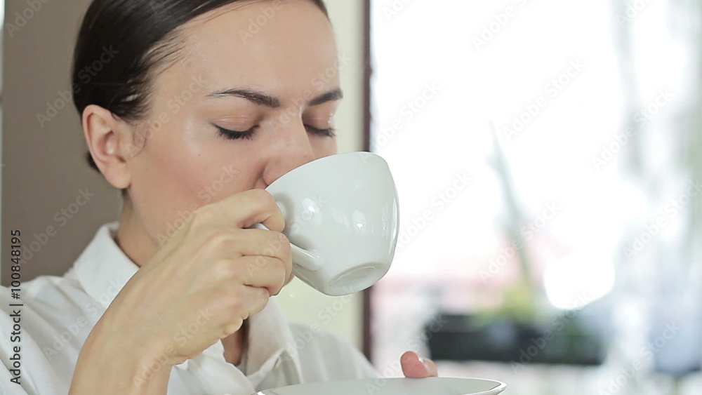 Portrait of young brunette woman drinking coffee at home in the morning, close up
Portrait of young brunette woman drinking coffee at home in the morning, close up
