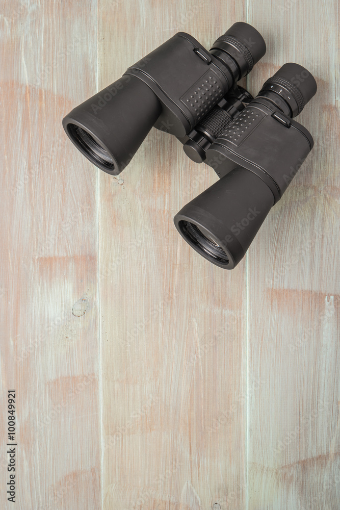 Binoculars on a natural blue wood surface. Top view with copy space Binoculars on a natural blue wood surface. Top view with copy space
