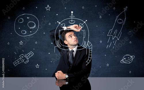 Sales person drawing helmet and space rocket