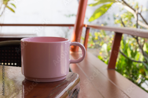 Pink coffee cup Placed on a wooden table