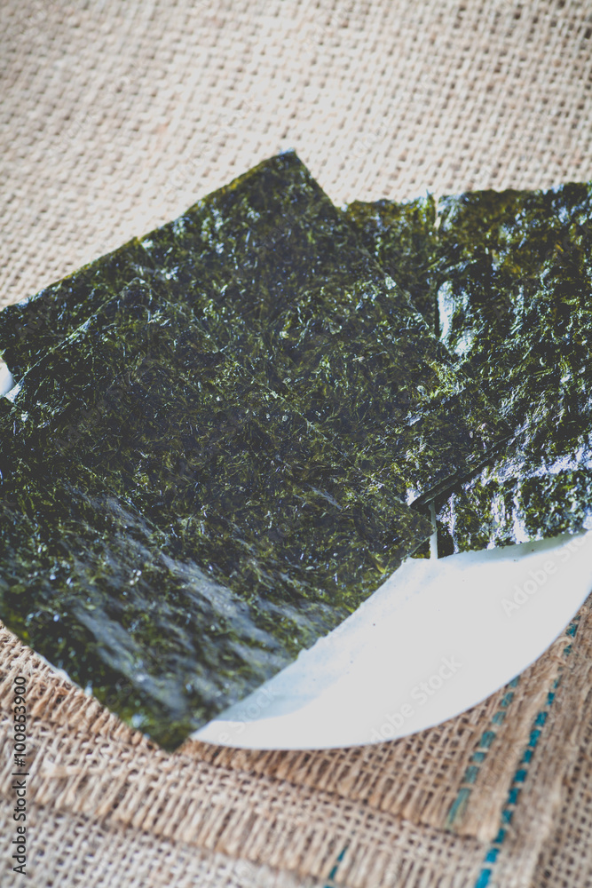 Nori , Japanese edible seaweed used as a wrap for sushi and onigiri