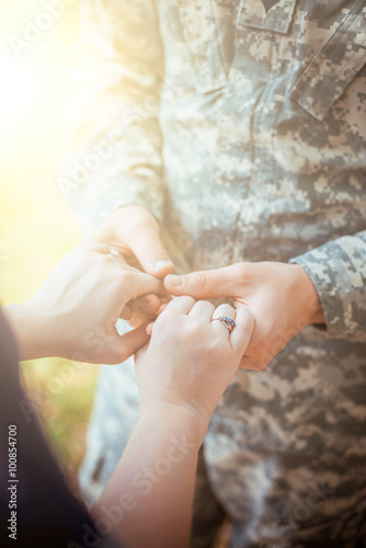 Married military couple holding hands