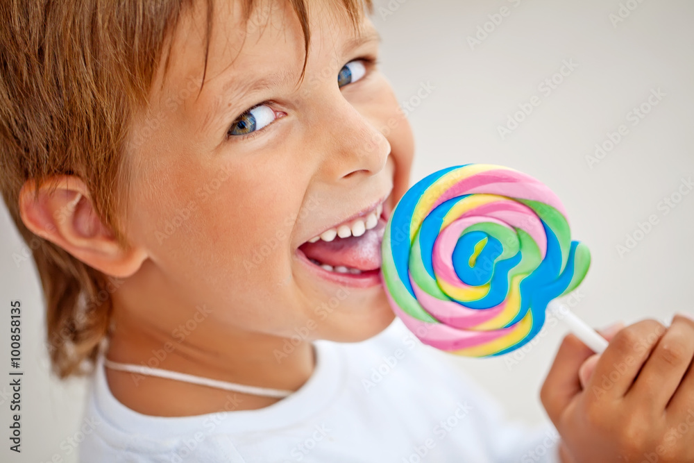 Happy kid with a big candy 