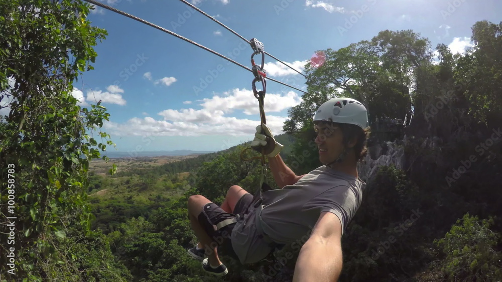 POV Young Happy Man Zip Lining In Tropical Jungle