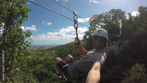 POV Young Happy Man Zip Lining In Tropical Jungle