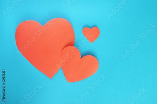 Red hearts paper on cyan paper background for Valentines day