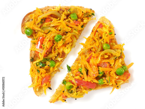 Indian food masala bread open sandwich made from a slice of wheat bread and cooked vegetables like tomato, onion, pea and carrot gratings.