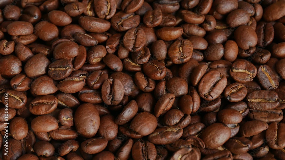 Light roasted coffee beans on rotating stand, UHD high angle macro Light roasted coffee beans on rotating stand, UHD high angle macro