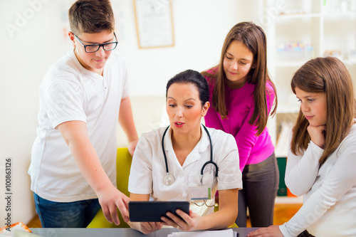 Female doctor and patient teenagers discussing health issues. Medical examination.