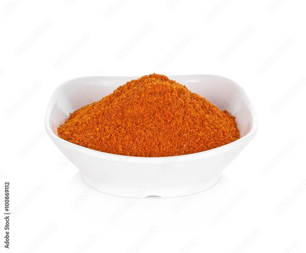 Powdered dried red pepper in a white bowl on white background Powdered dried red pepper in a white bowl on white background
