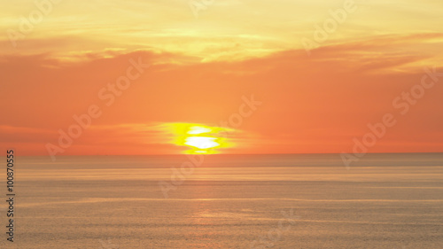 Beautiful soft orange sky above the sea. Sunset in background. Abstract orange sky. Dramatic golden sky at the sunset background.