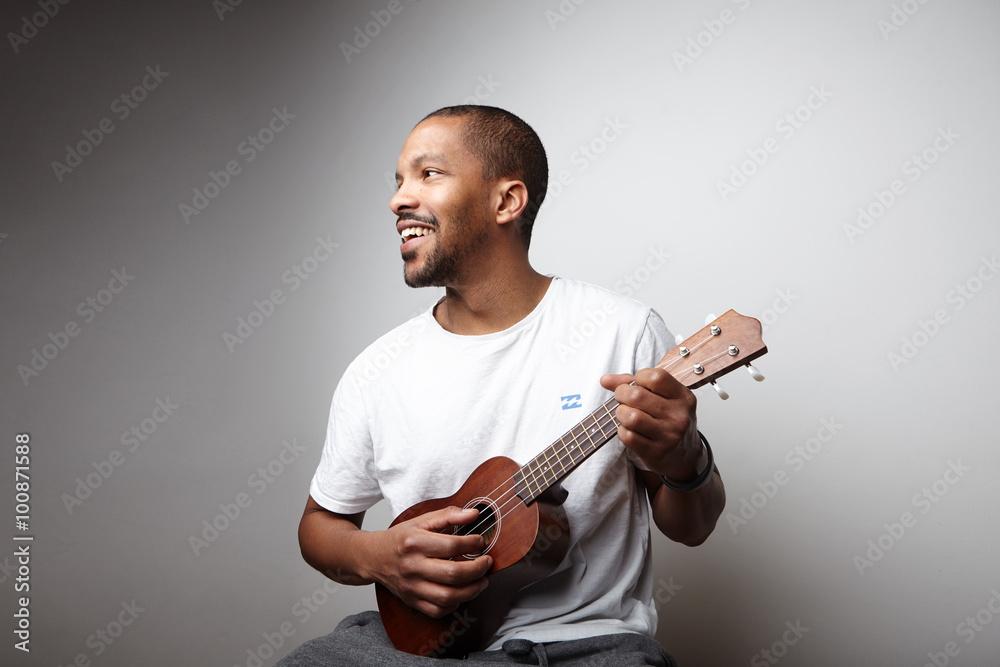 Black man with ukulele Stock Photo | Stock