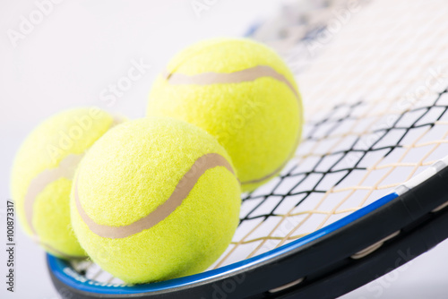 Three tennis balls and a racket.  © Viacheslav Yakobchuk