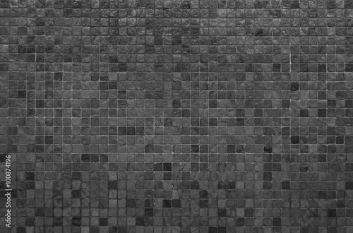 Grey and black mosaic wall texture and background..