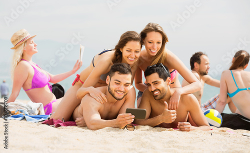 Friends doing selfie picture at sandy beach © JackF
