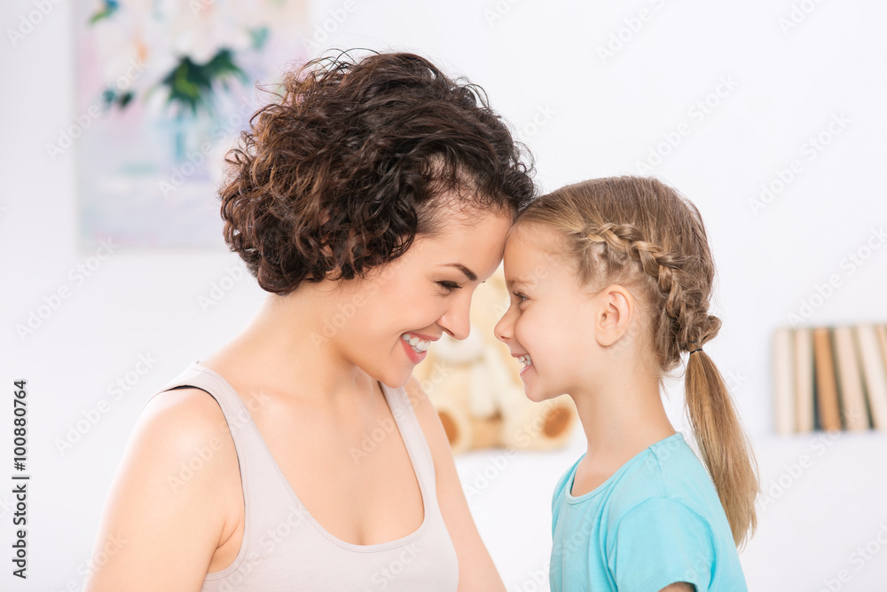 Mother and daughter are grinning to each other. Mother and daughter are grinning to each other.