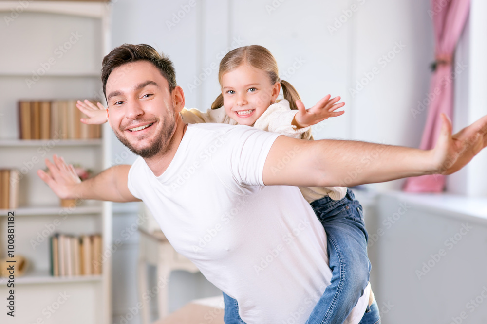Fototapeta premium Vivacious father and daughter laying together