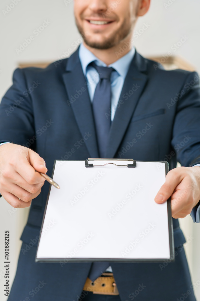 Nice office worker holding folder Nice office worker holding folder