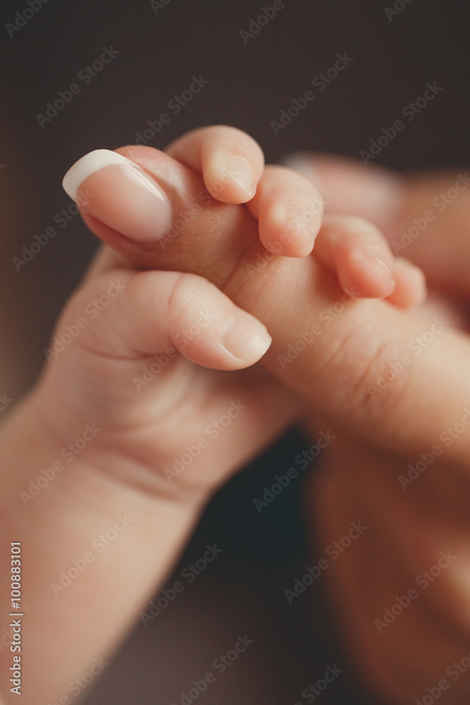 Newborn baby holding mother's finger Newborn baby holding mother's finger