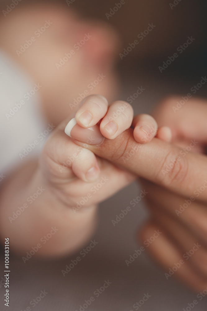 Newborn baby holding mother's finger Newborn baby holding mother's finger