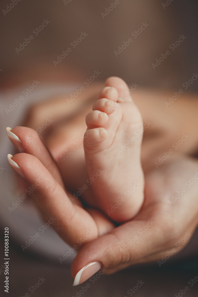 Children's legs on a mother's palm Children's legs on a mother's palm