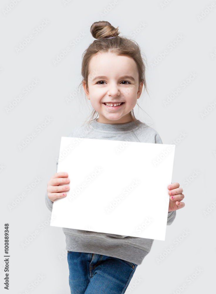 Girl with hair beam holding a white paper, you can place your text. isolated on a gray background Girl with hair beam holding a white paper, you can place your text. isolated on a gray background