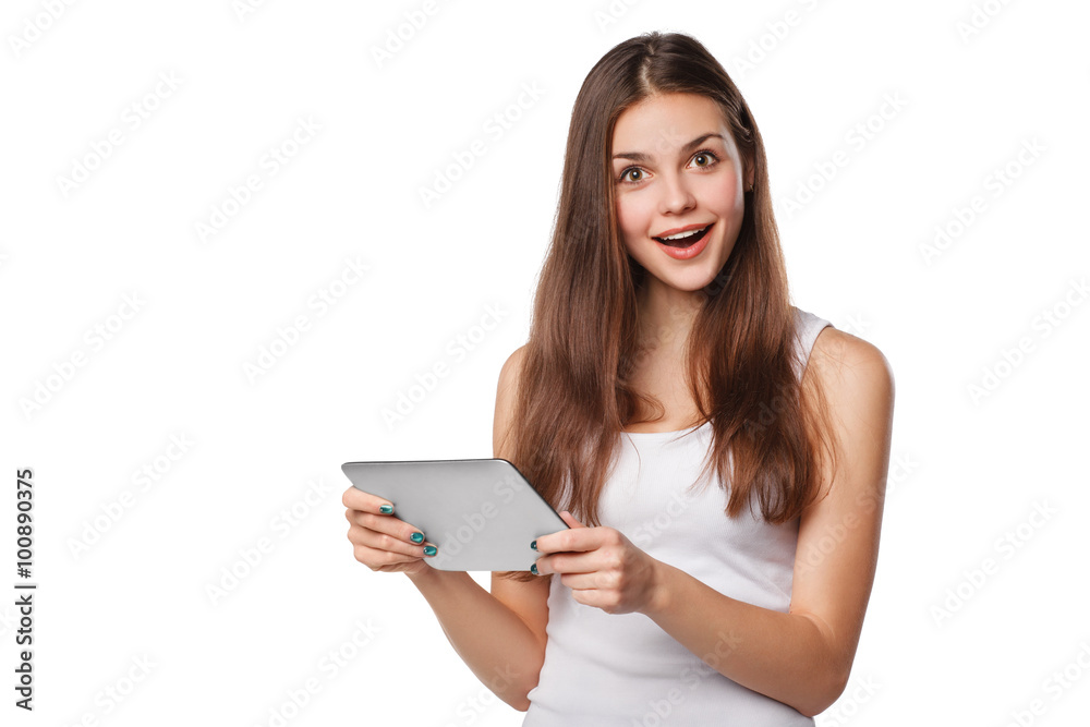 Attractive happy girl in white shirt using tablet. Excited woman with tablet pc, isolated on white background Attractive happy girl in white shirt using tablet. Excited woman with tablet pc, isolated on white background