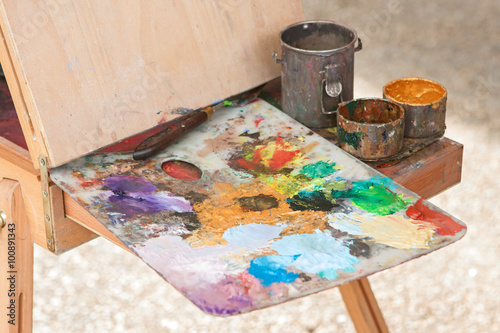 Artist Palette Covered With Oil Paints Sits Ready On Easel