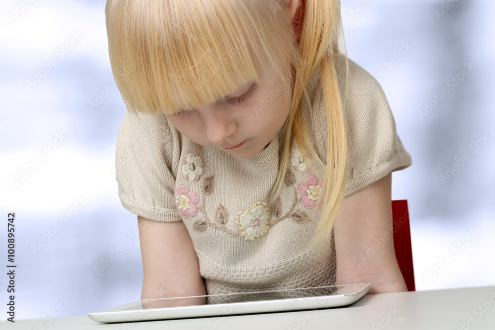 cute blonde little girl with digital tablet cute blonde little girl with digital tablet