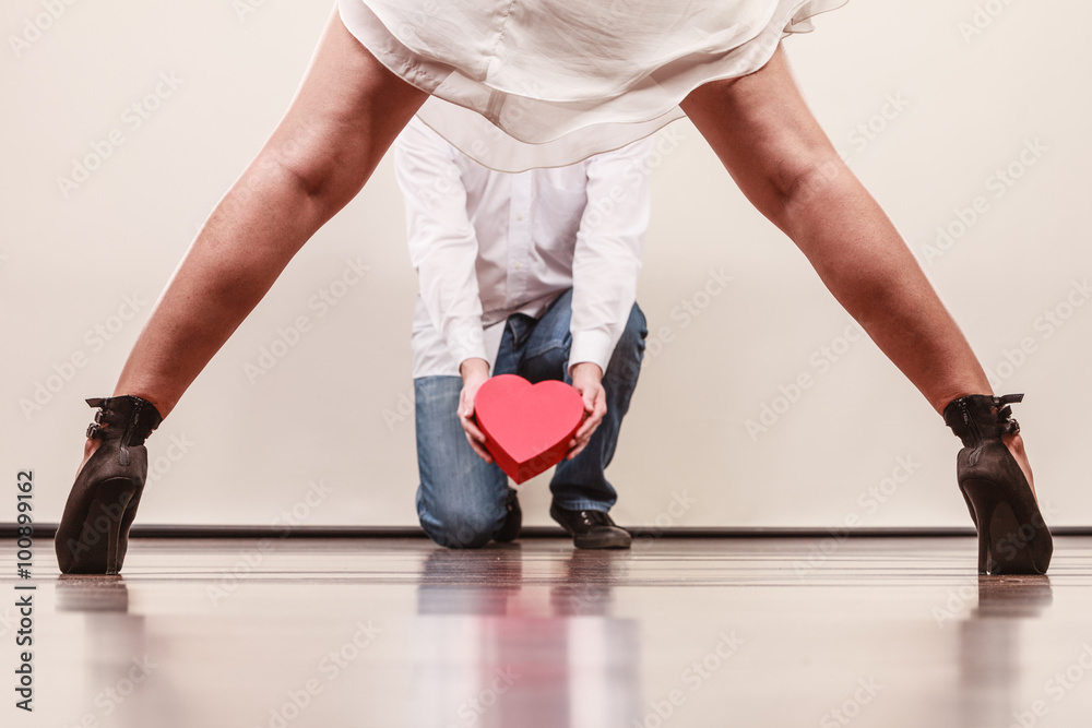 Man with heart shaped gift box for woman. Man with heart shaped gift box for woman.