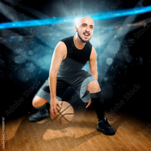 Square photo of basketball player in action dribbles in the gam