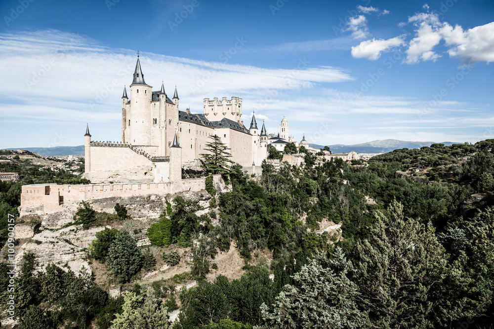 Segovia, Spain. The famous Alcazar of Segovia, rising out on a r Segovia, Spain. The famous Alcazar of Segovia, rising out on a r