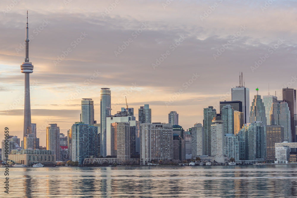 Downtown Toronto skyline :CN Tower apex and  Financial District skyscrapers - illuminated at sunset