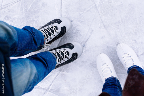 Woman and man  ice skating. winter outdoors on ice rink.