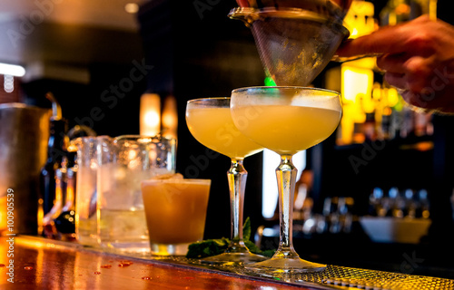 фотографія Cocktail being poured at a bar