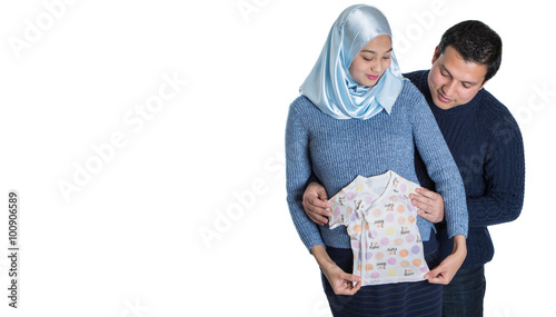 Young happy Muslim pregnant couple over white background