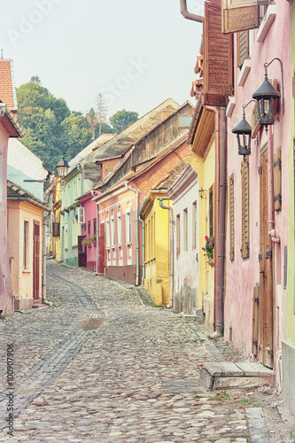 Picturesque street in Sighisoara Romania, toned image.