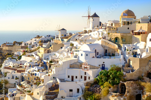 View of beautiful village Oia with whitewashed and colorful hous