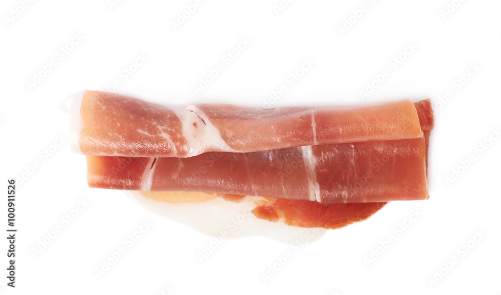 Folded prosciutto ham slice isolated