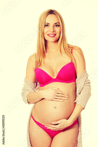 Pregnant woman in lingerie and cardigan © Piotr Marcinski