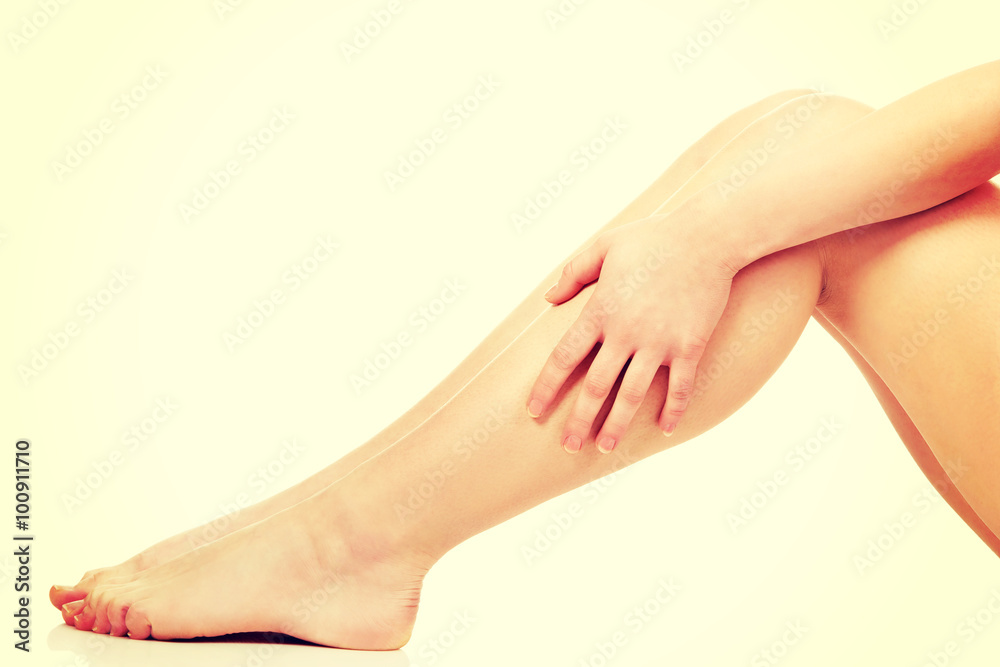 Woman massaging her legs. Woman massaging her legs.