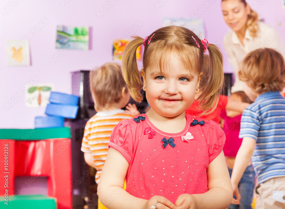 Fototapeta premium Portrait of a girl and kids group on background