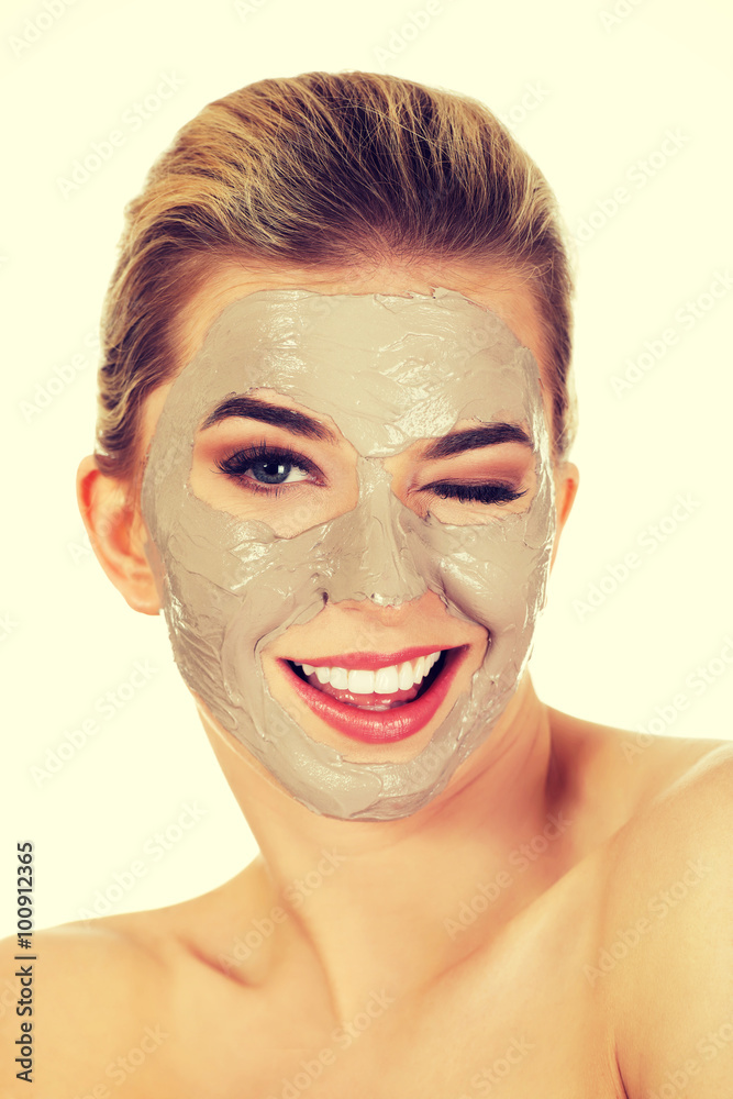 Young happy woman with facial mask.