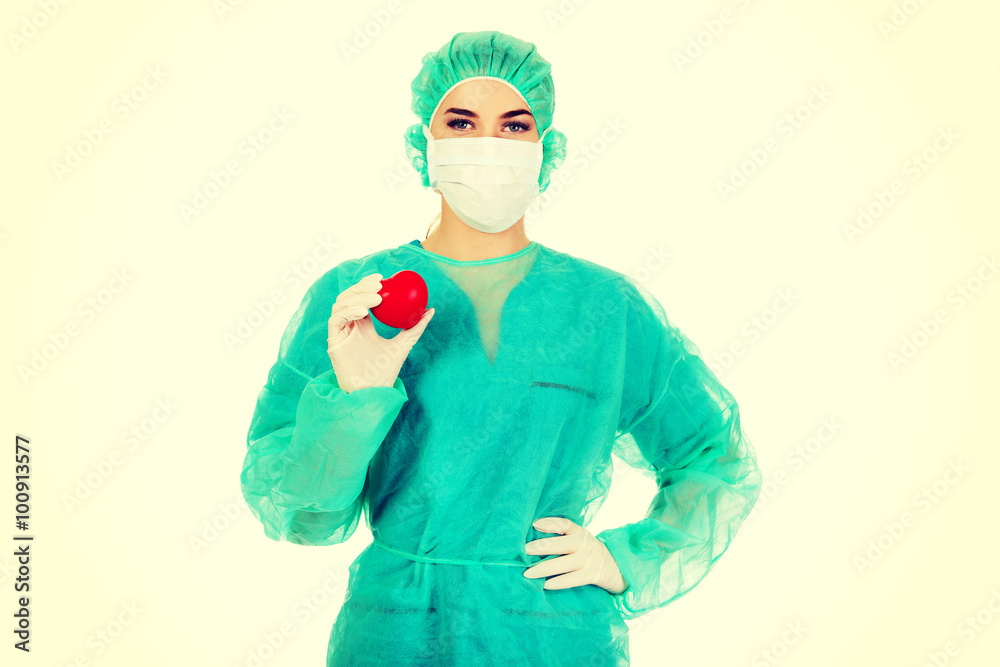 Female surgeon doctor holding heart Female surgeon doctor holding heart