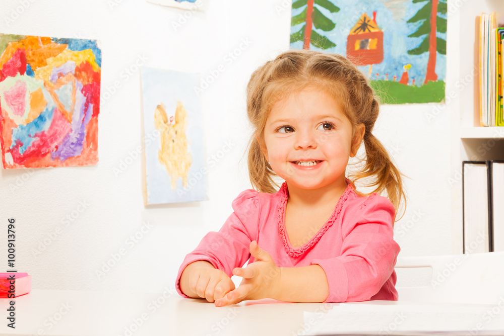 Cute little girl doing her lessons at the desk Cute little girl doing her lessons at the desk