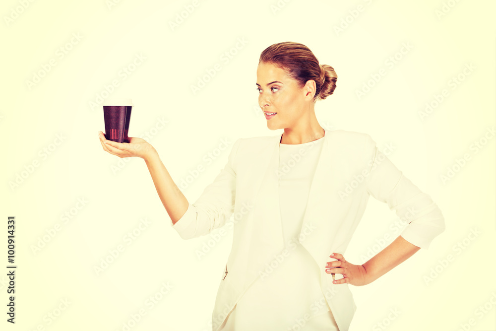 Businesswoman drinking coffee from paper cup Businesswoman drinking coffee from paper cup