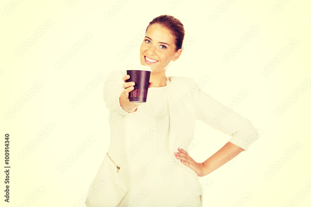 Businesswoman drinking coffee from paper cup